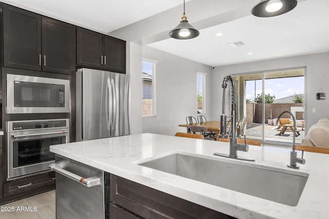 kitchen with plenty of natural light, visible vents, stainless steel appliances, and a sink
