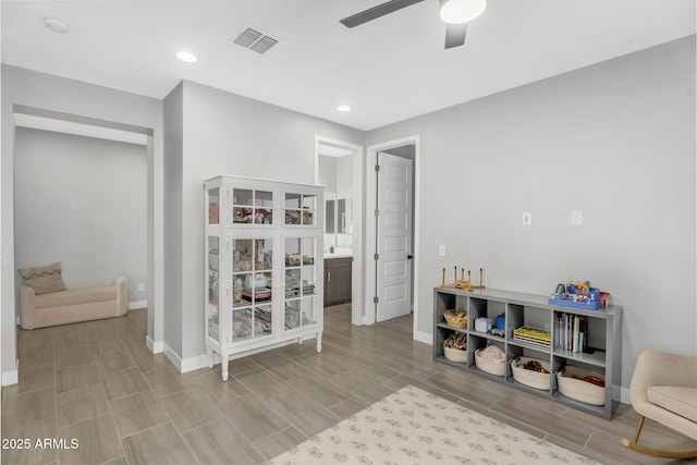 interior space with wood finish floors, ceiling fan, baseboards, visible vents, and recessed lighting