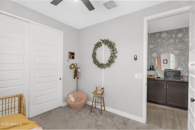 bedroom featuring carpet flooring, baseboards, wallpapered walls, and visible vents