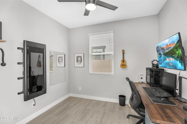 office featuring a ceiling fan and baseboards