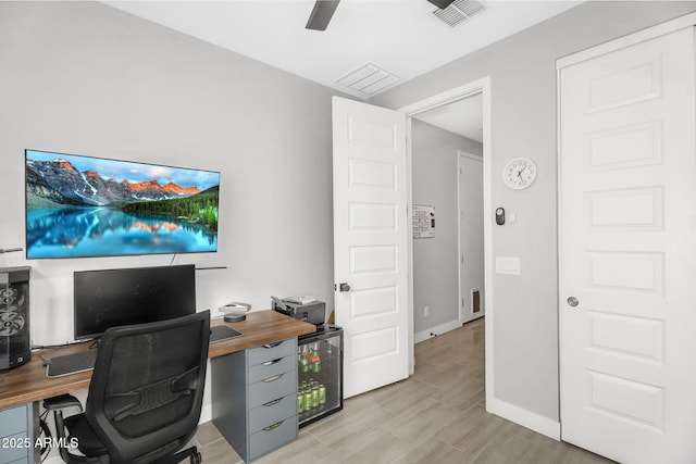 office area featuring baseboards, a ceiling fan, wine cooler, and visible vents