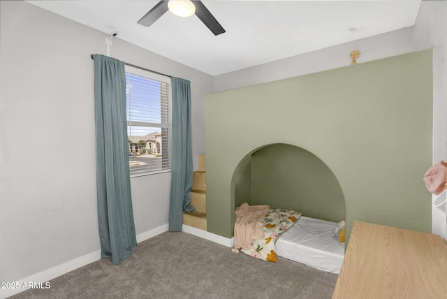 bedroom with baseboards, a ceiling fan, and carpet