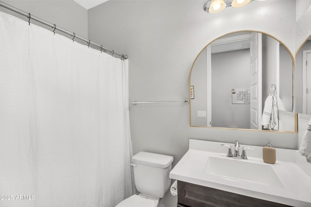 bathroom with toilet and vanity