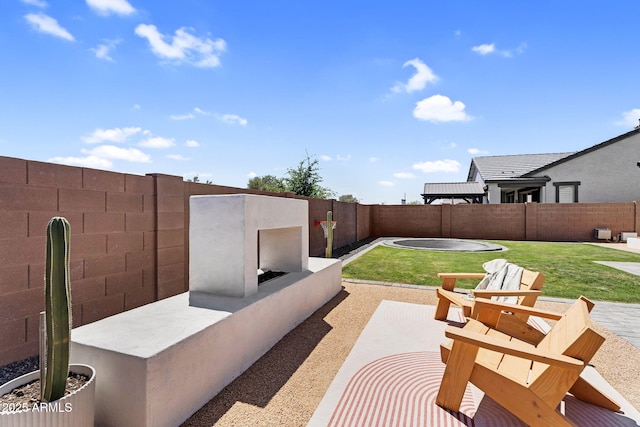 view of patio / terrace featuring a fenced backyard and a fireplace