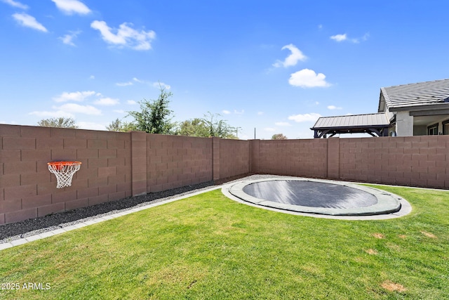 view of yard featuring a fenced backyard and a trampoline