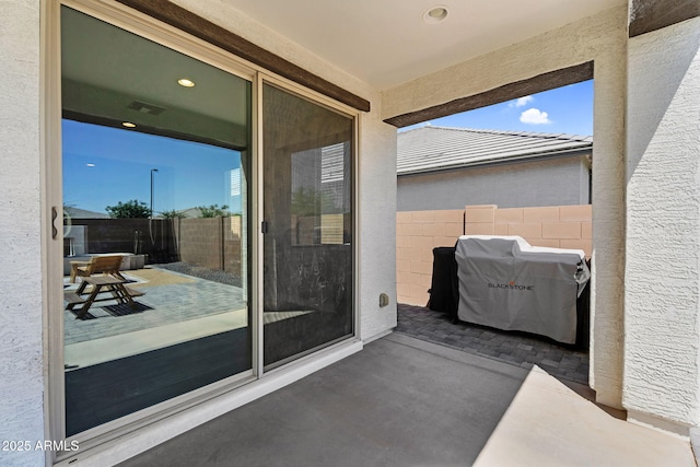 exterior space featuring visible vents, area for grilling, and fence