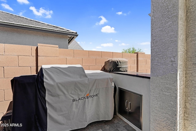 view of patio with fence and area for grilling