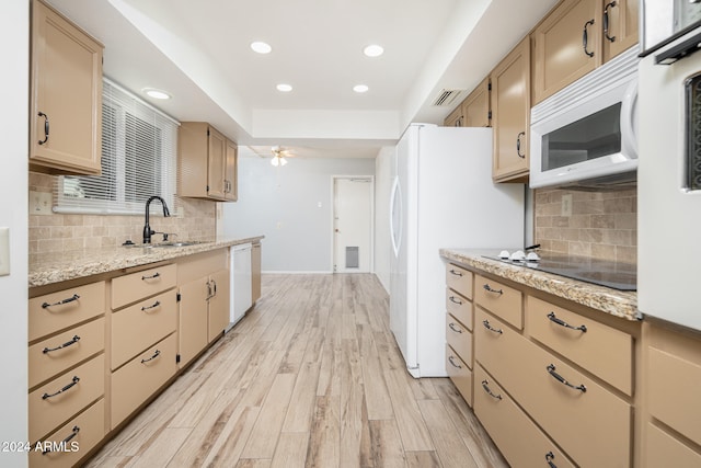 kitchen featuring light hardwood / wood-style flooring, backsplash, sink, light brown cabinetry, and white appliances