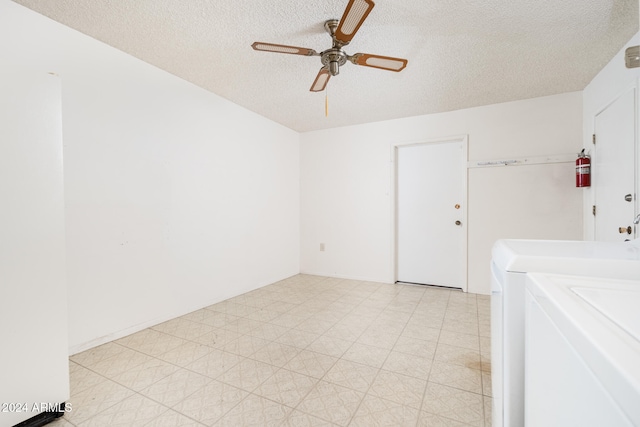 spare room with ceiling fan, washing machine and dryer, and a textured ceiling