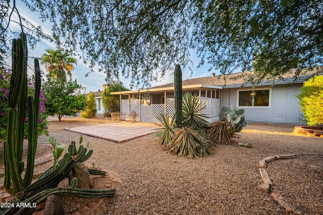 rear view of house with an outdoor fire pit and a patio