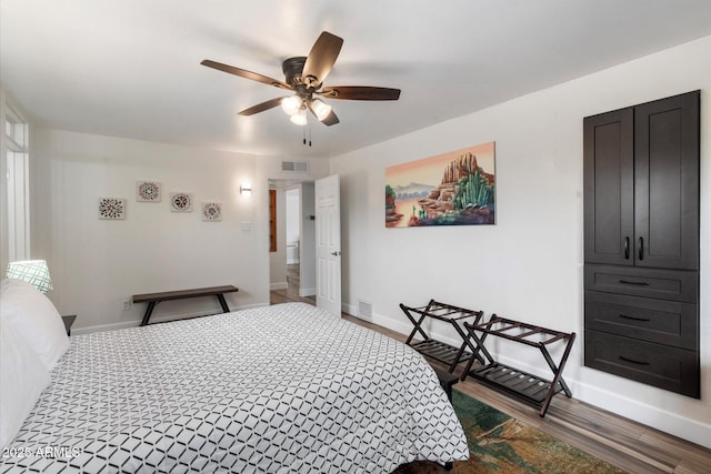11421 W Lakeshore Dr, Youngtown, AZ 85363 - bedroom featuring a ceiling fan, dark wood-style floors, baseboards, and visible vents