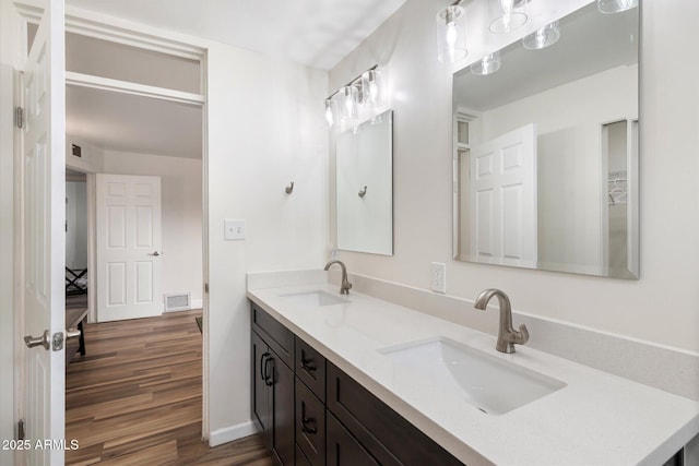 11421 W Lakeshore Dr, Youngtown, AZ 85363 - full bathroom featuring visible vents, a sink, double vanity, and wood finished floors