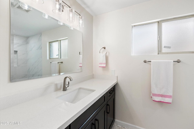 11421 W Lakeshore Dr, Youngtown, AZ 85363 - bathroom with vanity, baseboards, and visible vents