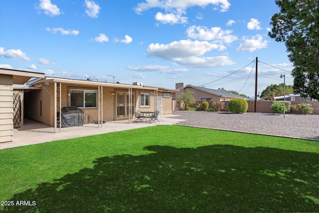 11421 W Lakeshore Dr, Youngtown, AZ 85363 - back of house featuring a patio, fence, a lawn, and stucco siding