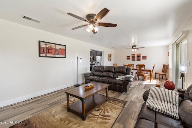 11421 W Lakeshore Dr, Youngtown, AZ 85363 - living area featuring visible vents, light wood-style flooring, and a ceiling fan