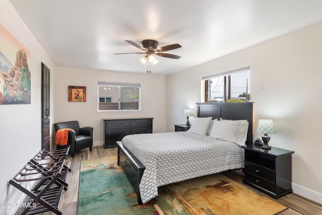 11421 W Lakeshore Dr, Youngtown, AZ 85363 - bedroom with baseboards, ceiling fan, and wood finished floors