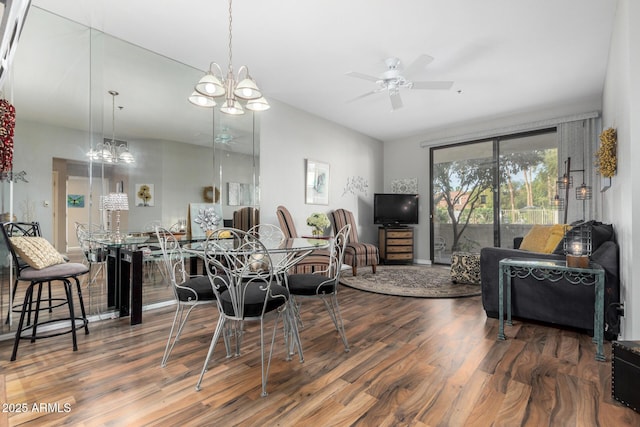 dining room featuring wood finished floors and ceiling fan with notable chandelier