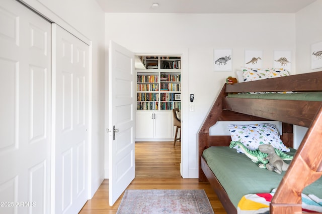 bedroom with a closet and light hardwood / wood-style flooring