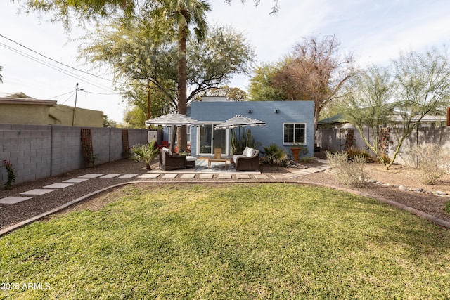 rear view of house with a lawn and a patio area