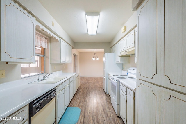 kitchen featuring white appliances, light wood-style flooring, a sink, light countertops, and white cabinets