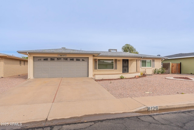 single story home with stucco siding, driveway, a garage, and fence