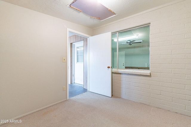 carpeted empty room with attic access