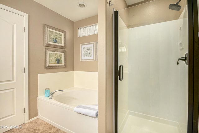 bathroom featuring plus walk in shower and tile patterned floors