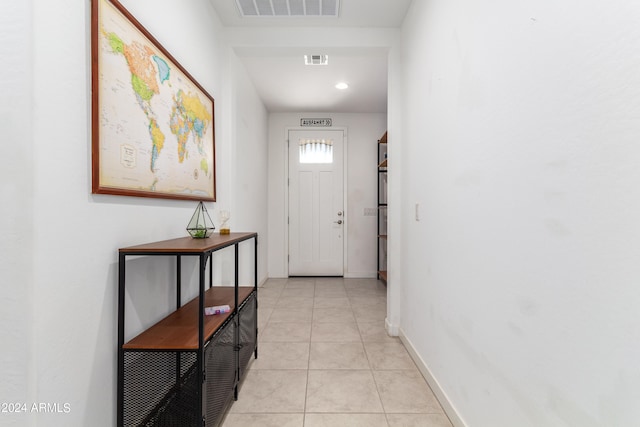 doorway to outside with light tile patterned floors