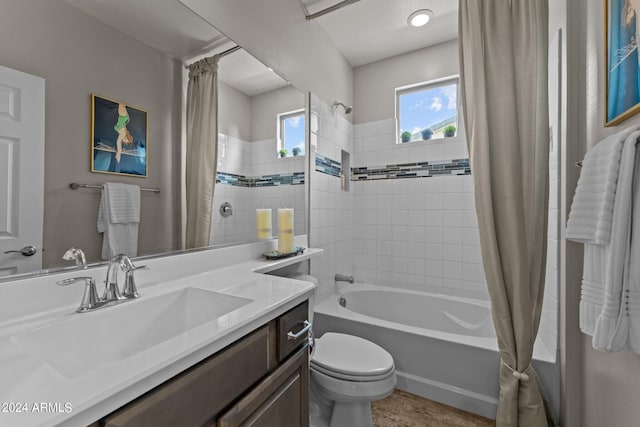 full bathroom featuring vanity, shower / bath combo with shower curtain, and toilet