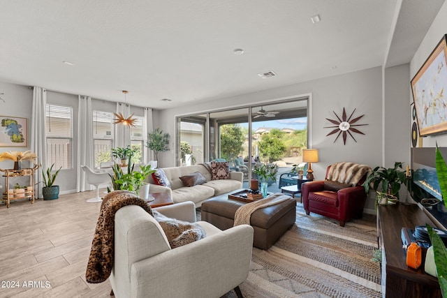 living room featuring light wood-type flooring and plenty of natural light