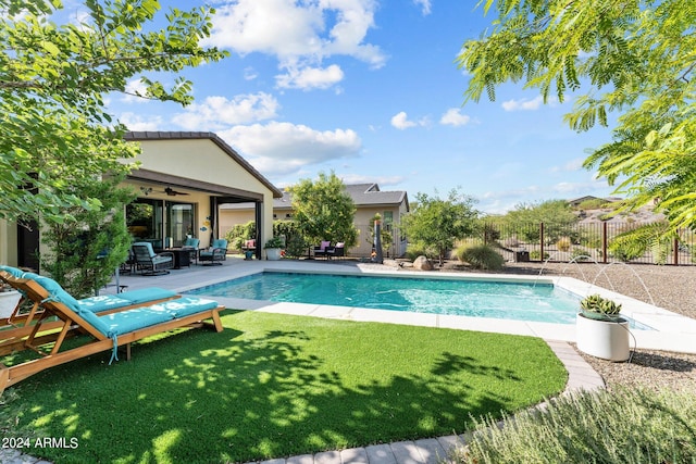 view of pool with a patio, a lawn, outdoor lounge area, and ceiling fan