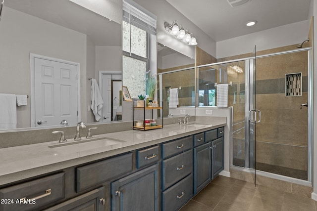 bathroom with vanity, an enclosed shower, and tile patterned floors