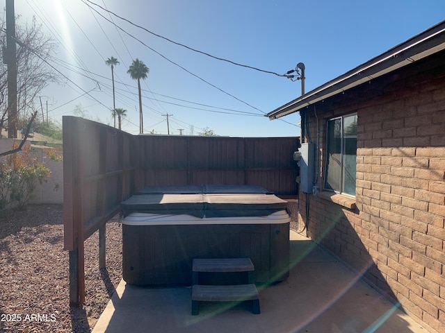 view of yard with a fenced backyard and a hot tub