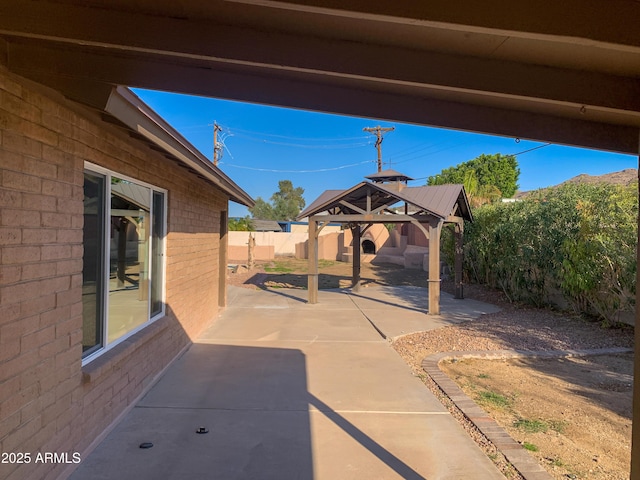 view of patio with a gazebo and a fenced backyard