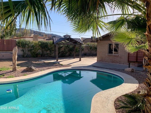 view of swimming pool with a gazebo, a fenced in pool, and a fenced backyard