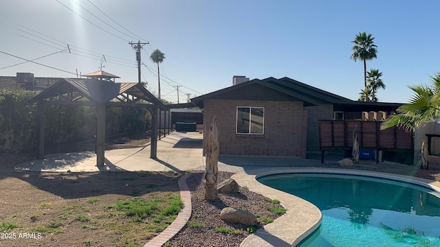 pool with fence and a patio area