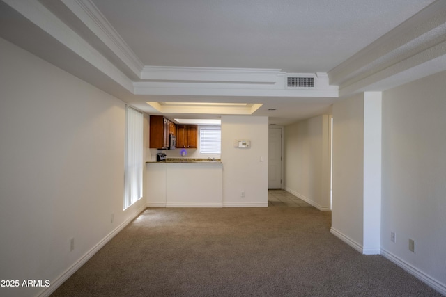 3330 W Danbury Dr Unit E203, Phoenix, AZ 85053 - unfurnished living room with a raised ceiling, carpet, and ornamental molding
