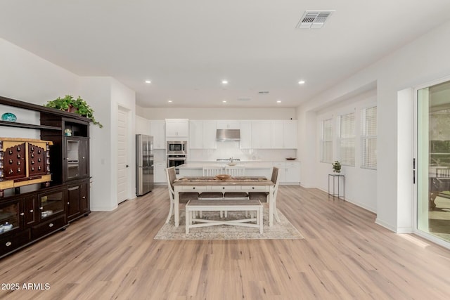 dining area featuring light hardwood / wood-style floors and sink