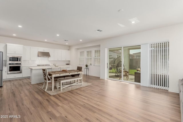 dining area with light wood-type flooring