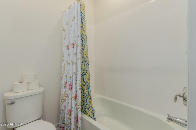 bathroom featuring shower / tub combo with curtain and toilet