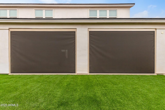 garage featuring a lawn