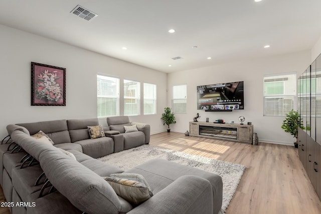 living room featuring plenty of natural light and light wood-type flooring