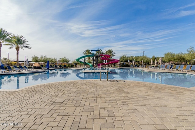 view of swimming pool featuring a patio area and a water slide