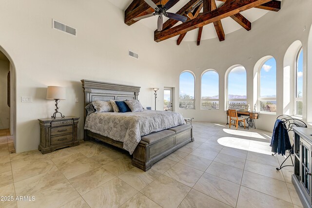 bedroom with visible vents, arched walkways, high vaulted ceiling, and beam ceiling