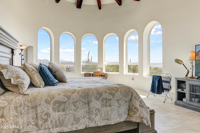 tiled bedroom with beamed ceiling and a high ceiling