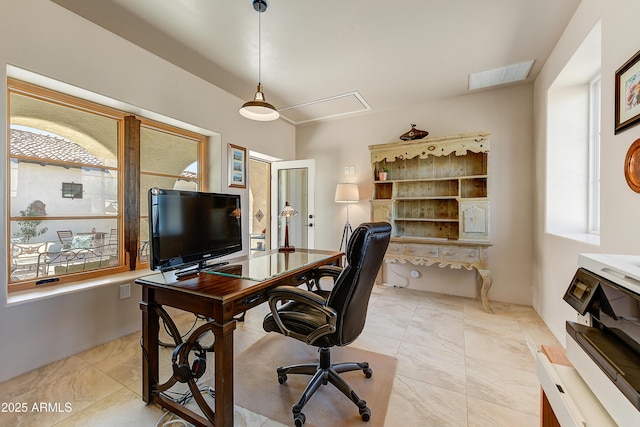 office space featuring attic access and visible vents