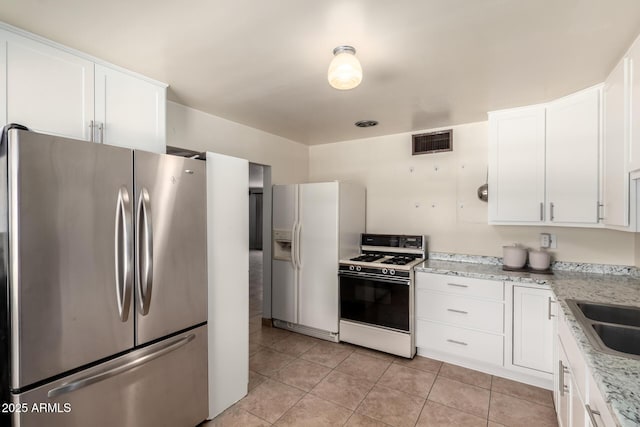 3617 W Luke Ave, Phoenix, AZ 85019 - kitchen featuring white appliances, white cabinets, and visible vents