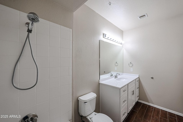 5401 E Van Buren St Unit 2095, Phoenix, AZ 85008 - bathroom with wood finish floors, visible vents, a tile shower, and vanity