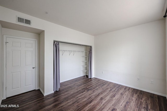 5401 E Van Buren St Unit 2095, Phoenix, AZ 85008 - unfurnished bedroom featuring dark wood-type flooring, a closet, visible vents, and baseboards