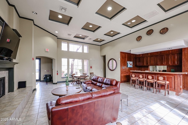 5401 E Van Buren St Unit 2095, Phoenix, AZ 85008 - living room featuring visible vents, a fireplace with raised hearth, coffered ceiling, arched walkways, and a high ceiling
